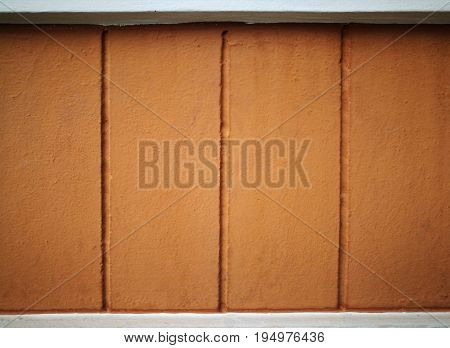 Brown concrete wall with white frame on top and bottom. Use for presentation background with four columns of topics