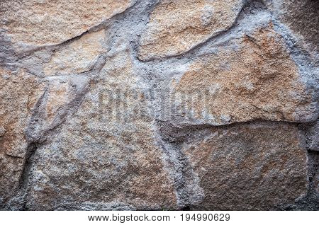 A Background With A Closeup Of A Large Brown Natural Stones Joined With Grey Cement