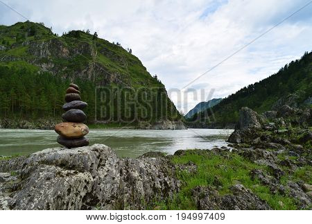 Stone pyramid near Katun river in Altay mountains. Chemal Altay Republic Siberia Russia.