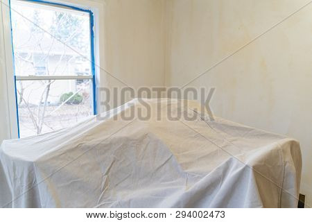 Furniture Covered With A Painting Tarp For Protection During Home Improvement Renovations. Walls Cov