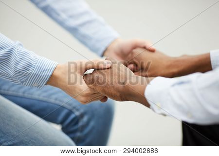Closeup Of Two People Holding Hands Heartily During Therapy Se4ssion In Support Group, Copy Space