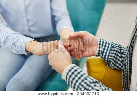 Close Up Of Two People Holding Hands Heartily During Therapy Se4ssion In Support Group, Copy Space