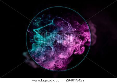 Close-up сloud Of Pink And Blue Smoke  Blown Under A Magnifying Glass On A Black Isolated Background