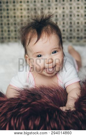 Portrait Of A Newborn Baby With His Tongue Sticking Out