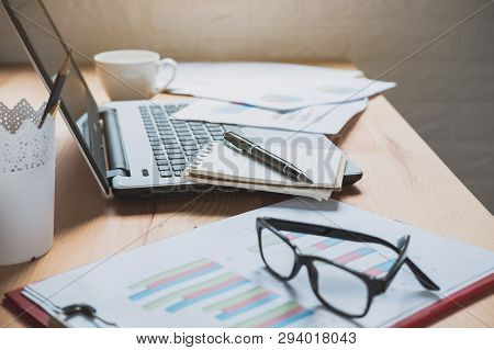 Desk Office With Marketing Graph Statistics Analysis