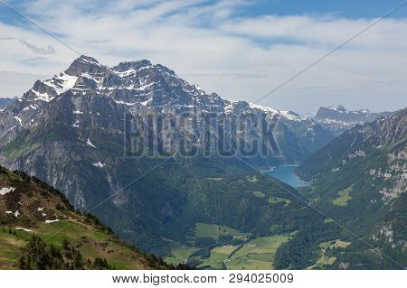 Snowcapped Swiss Glaernisch Mountain, Kloentalersee, Cloudy Blue Sky