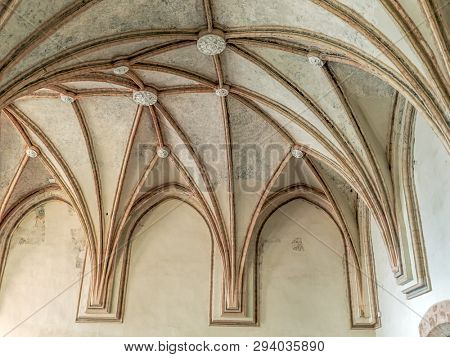 MALBORK, POLAND - 15 AUGUST, 2013: Gothic cloister canopy of Teutonic Malbork castle, Poland. Malbork castle is the largest brick fortress in the world