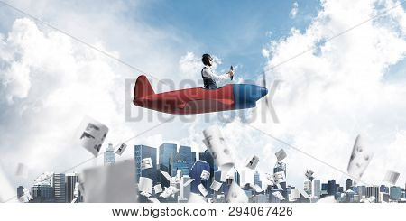 Business Accounting And Statistics Concept With Funny Pilot. Aviator Driving Propeller Plane Above F