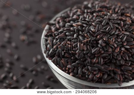 Nerone Black Rice In A Glass Bowl On A Black Background. (organic Black Nerone Rice).