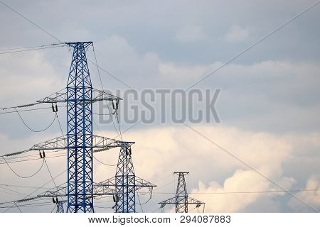 High Voltage Power Line Poles With Electrical Wires On Background Of Evening Sky With Clouds. Electr
