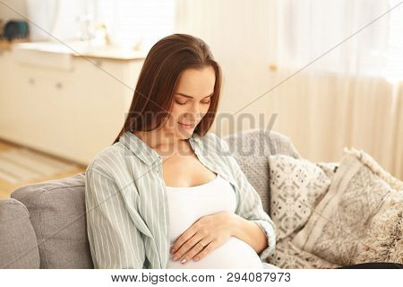 Happiness, Joy, Youth And Motherhood Concept. Pregnant Girl Having Amazed Facial Expression, Looking