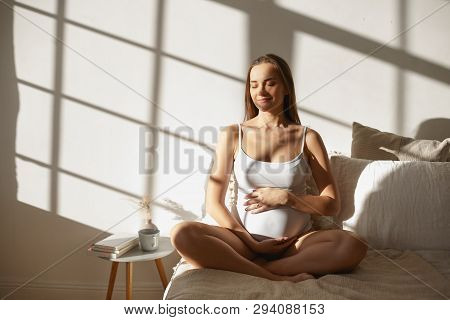 Family, Childbirth, Expectation And Pregnancy Concept. Peaceful Calm Young Lady Expecting First Chil