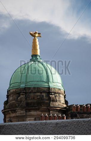 A Copper Dome Shaped Roof With Gold Decoration Above The Houses Of Edinburgh