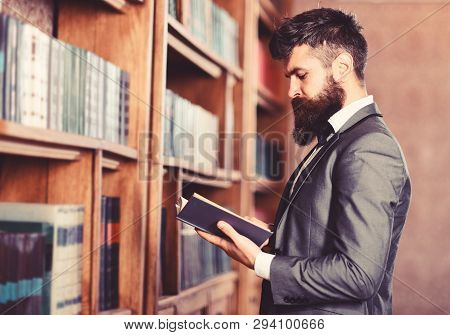 Bearded Man Reading Book In The Librar