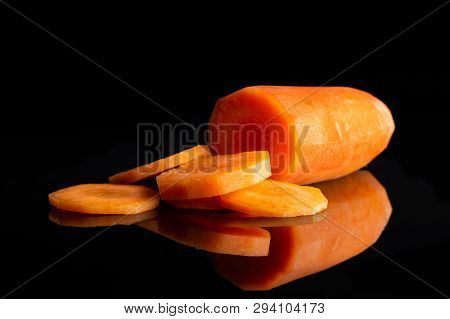 Group Of One Half Five Slices Of Fresh Orange Carrot Isolated On Black Glass