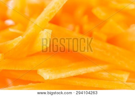 Macro Closeup Of Lot Of Pieces Of Fresh Orange Carrot Cut Into Thin Noodles Isolated