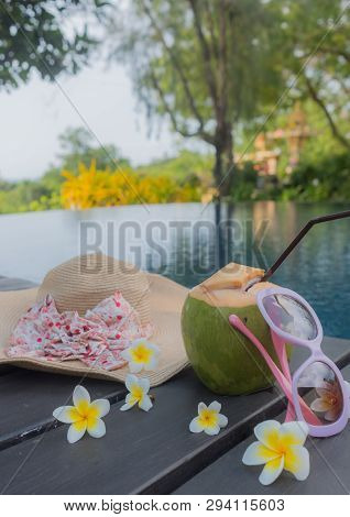 Coconut, Glasses And Hat At The Swimming Pool.summer Concept