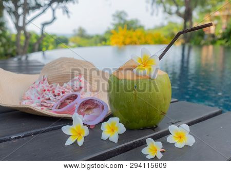 Coconut, Glasses And Hat At The Swimming Pool.summer Concept