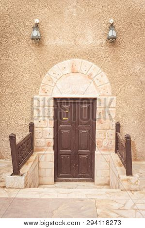 A Door Of An Arabic House In Old Dubai, United Arab Emirates; With Traditional Lamps