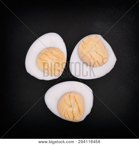 Three Halves Of A Boiled Quail Eggs. Closeup. Vignette.