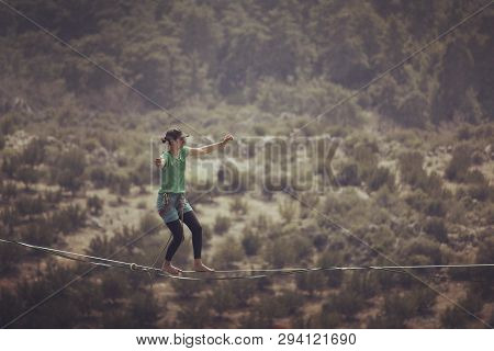 Woman Balancing On The Rope Concept Of Risk Taking And Challenge.