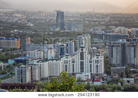 Almaty, Kazakhstan, 05.05.2017. Top View On The Modern City In The Mountains At Sunset