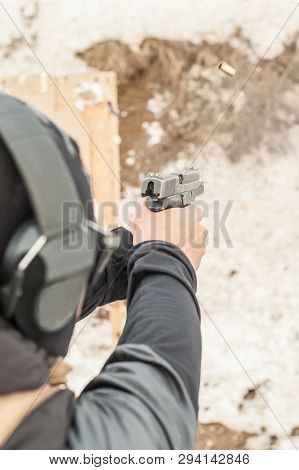 Shooting On Target In Shooting Range. Back Close-up Detail View