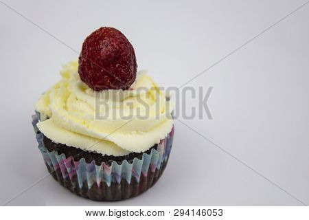 Chocolate-banana Muffins With Cream And Strawberries On A White Background. Copy Space
