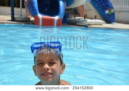 Teenager Boy Wearing Mask Swimming In The Pool. Happy Holiday Concept. Cute Happy Little Boy Swimmin