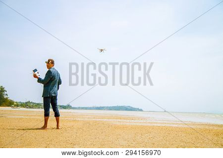 A Man On The Beach Launches A Kopter.