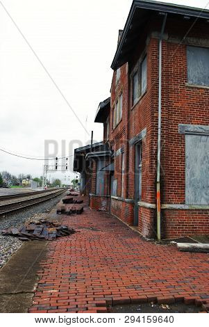 Abandoned Brick Train Depot With Tracks And Graffiti