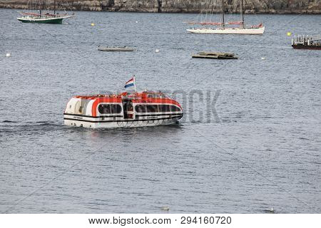 BAR HARBOR, MAINE, USA - OCTOBER 13, 2016: Bar Harbor  with smal tourist boat from cruise ship Zuiderdam from Holland American Line  with early afternoon lights during Autumn season
