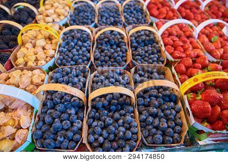 Fresh Boxes Of Assorted Berries On Display At The Farmers Market