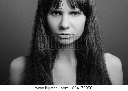 Distrustful Looking Beautiful Girl. Insecure Facial Expression. Black And White Closeup Portrait Of 