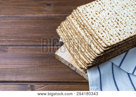 Stack Of Matzah Or Matza , Jewish Traditional Passover Celebration On A Wooden  Table With Copy Spac