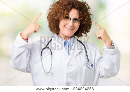 Middle ager senior doctor woman over isolated background Smiling pointing to head with both hands finger, great idea or thought, good memory