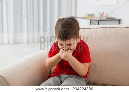 Little Boy Suffering From Nausea In Living Room