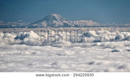 Mount Rainier Covered With Snow And Ice Above Clouds. View From Above. Seattle. Wa. Usa