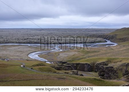 Deep Gorge, At The Bottom Of Which Flows A Mountain River And Goes Into A Lava Field Covered With Mo