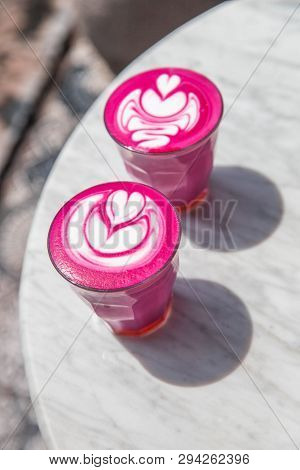 Two Colorful Trendy Pink Beetroot Latte On White Marbel Background.