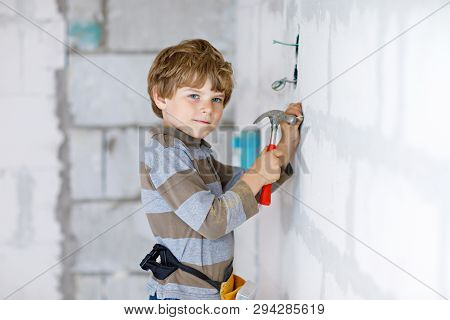 Little Kid Boy Helping With Toy Tools On Construction Site. Funny Child Of 6 Years Having Fun On Bui