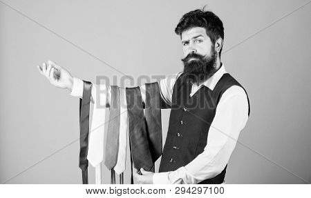 This Tie Is A Must Have. Brutal Hipster Holding Colorful Tie Collection. Bearded Man Choosing Neck T