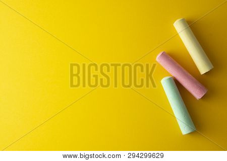 Education Template. Colorful Chalks Over Yellow Background With Copy Space. Childhod, Business And D