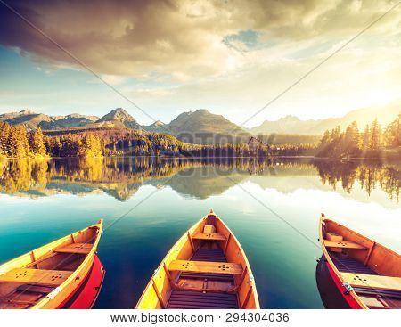 Calm lake in National Park High Tatra. Location place Strbske pleso, Slovakia, Europe. Photo toned style instagram filters, vintage effect. Scenic image of popular travel destination. Beauty of earth.