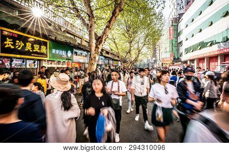 6 April 2019, Wuhan Hubei China : Moving Forwad Crowd Of Chinese People In Streetfood Street In Wuha