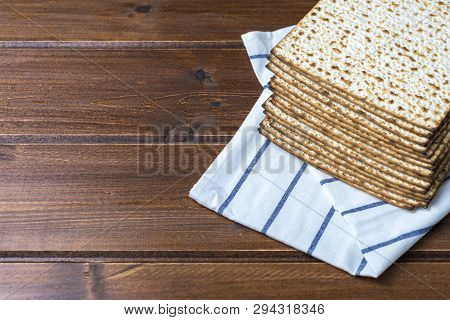 Stack Of Matzah Or Matza , Jewish Traditional Passover Celebration On A Wooden  Table With Copy Spac