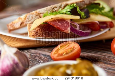 Sandwich With Bacon, Cheese, Garlic, Jalapeno Pepper And Herbs On A Plate, On A Wooden Background