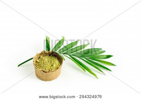 Henna Powder For Dyeing Hair And Eyebrows And Drawing Mehendi On Hands, Isolate With Green Palm Leaf