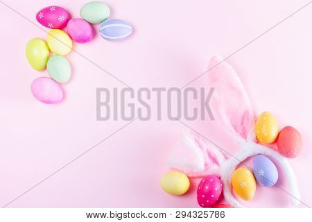 Easter Rabbit Flaffy Ears And Colored Easter Colored Eggs Frame On Pink Plain Background, Flat Lay W