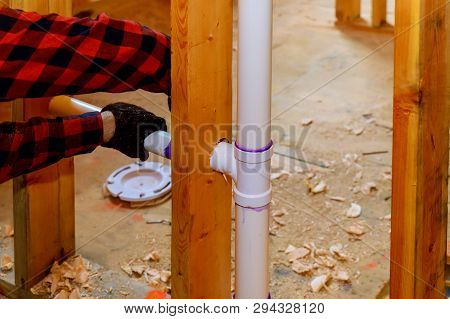 Close Up On T Joint And Pipes For Home Sewage System, In Wood Wall, Drain And Vent Plumbing System